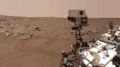 A photo showing half of the Perseverance rover, a vehicle craft with a camera attached to it, on the surface of Mars