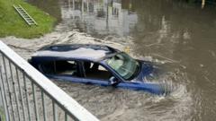 Cars and rail lines submerged as flood risk persists