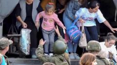 A still image taken from a handout video provided by the Russian Defence Ministry press-service shows Russian peacekeepers evacuating civilians at an undisclosed location in Nagorno-Karabakh, 20 September 2023.