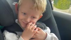 Boy surprised by teddy bear with hearing aids