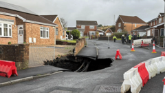 Sinkhole gets bigger as storm delays homecoming