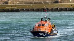 Pair in rubber dingy saved after washing into wall