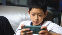 A Chinese child gaming on a phone