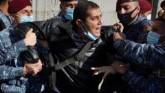 A demonstrator is taken away by law enforcement officers during an opposition rally to demand the resignation of Armenian Prime Minister Nikol Pashinyan