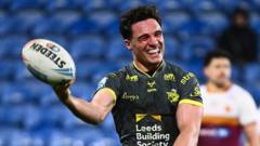 Leeds run riot at Huddersfield to go top