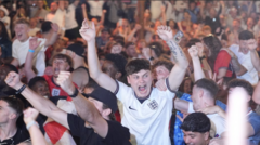England fans in Manchester hug each other after win