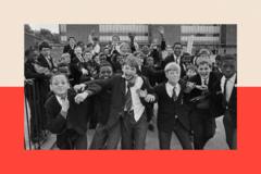 A group of boys run towards the camera, on a playground