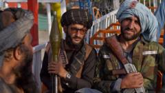 Taliban fighters pose with weapons at a fairground on 28 September, 2021