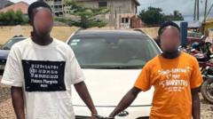 Foto of two pipo wey dem handcuff