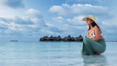 A woman enjoying the blue sea in an afternoon in the Maldives - stock photo