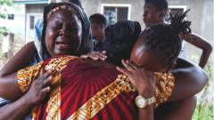 Grieving relatives of di cult victims for di Kenyan coastal town of Kilifi