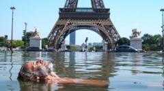 A man lies in a pool in front of the Eiffel Tower.