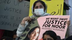 A woman holds a sign saying "justice for Noor"