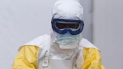 An Ebola worker in Guinea - archive