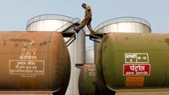 A worker walks atop a tanker wagon at an oil terminal near Kolkata.