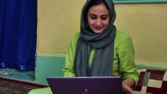 Kashmiri woman photojournalist Sanna Irshad Mattoo looking at her laptop at her residence in Srinagar
