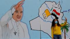 Woman in Baghdad takes selfie with Pope mural