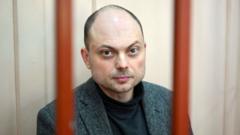 Russian opposition activist Vladimir Kara-Murza sits on a bench inside a defendants' cage during a hearing at the Basmanny court in Moscow on October 10, 2022