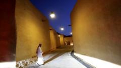 A Saudi man walks past renovated buildings at the historic city of Diriyah