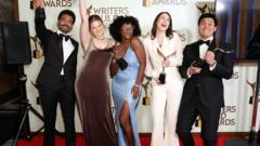 Hollywood writers and actors pose on the red carpet.