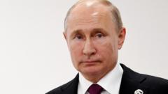 Russian President Vladimir Putin looks on during talks with British Prime Minister Theresa May on the first day of the G20 summit in Osaka, Japan, 28 June 2019