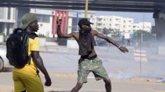 A protestor throws a rock during a demonstration of members of the Guinean opposition,