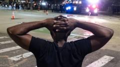 Black man under arrest with hands on head