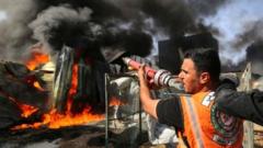 A Palestinian firefighter participates in efforts to put out a fire at a sponge factory on Monday