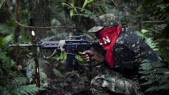 Members of the Ernesto Che Guevara front, belonging to the National Liberation Army (ELN) guerrillas, shoot during a training in the jungle, in Choco department in Colombia, on May 26, 2019