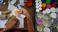 In this picture taken on April 21, 2022, a health worker packs medicines in Lady Ridgeway Hospital for Children in Colombo. - Sri Lanka used to import around 85 percent of its pharmaceutical supplies but is suffering its worst economic crisis since 1948.