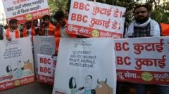 Activists from the Hindu Sena group protest with placards reading "BBC quit India" and "BBC beating day" outside the BBC office in Delhi, 15 February