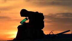 A boy drinks water during a heat wave