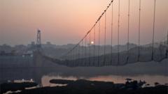 A view of a damaged suspension bridge after it collapsed on Sunday, in Morbi town in the western state of Gujarat, India, November 1, 2022.