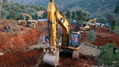 A team of diggers on site attempting to rescue the child