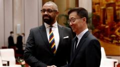 James Cleverly and Chinese Vice President Han Zheng shake hands in the Great Hall of the People in Beijing,