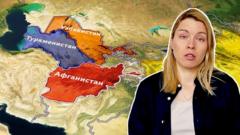 Девушка смотрит в кадр на фоне карты Афганистана