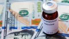 UKRAINE -2020/04/08: In this photo illustration a vial labelled Coronavirus vaccine seen displayed on one hundred US dollar banknotes.