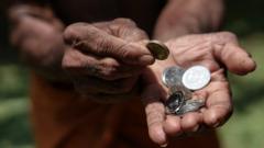 Coins in dark working hands. Beyond the poverty line in Asian countries.