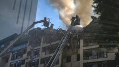 Firefighters at scene of wrecked apartment block in Kyiv, 26 Jun 22