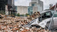A car is seen under rubble after a building was destroyed by Hurricane Ida on August 30, 2021 in New Orleans, Louisiana