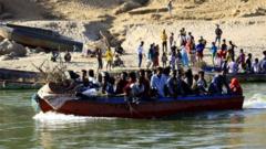 Ethiopians who fled the ongoing fighting in Tigray region, use boats to cross the Setit river on the Sudan-Ethiopia border in Hamdayet village in eastern Kassala state, Sudan November 22, 2020