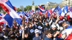 Supporters wave French flags as they gather ahead of a campaign rally of French far-right Reconquete! party President and presidential candidate Eric Zemmour on the Trocadero square in Paris on 27 March 2022