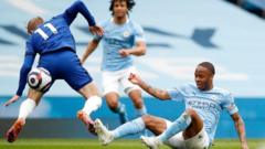 Manchester City's Raheem Sterling makes a challenge