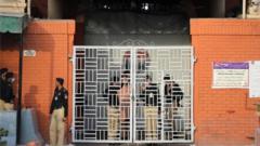 Police officers stand guard outside a Lahore district jail where the special court announced its verdict. Photo: 20 March 2021