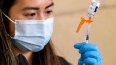 a nurse loads a syringe with vaccine