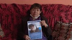 Teresa Salas Carrasco (67) carries a photo of her daughter Alison Fernandez (30), who on the morning of August 13th went out to the local market and did not return home.