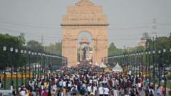 People crowd as they visit the India Gate in New Delhi on April 23, 2023.