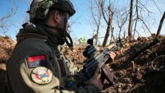 An officer with Ukraine's 77 Brigade stands in a trench in Bakhmut, eastern Ukrainian