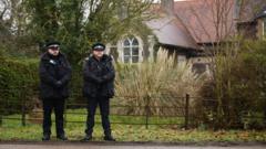 Andrew in custody as police search two addresses