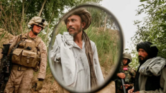 An Afghani citizen is seen in the mirror of his motorcycle after being stopped and searched by US Marines while patrolling in the Karez-e Sayyidi area near Marjah district in Helmand, Afghanistan, 2010IMAGE SOURCE,ASMAA WAGUIH